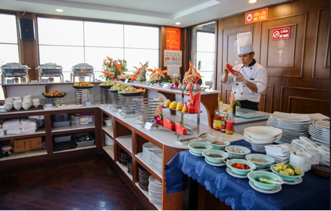 The CatBa Catamaran kitchen with the chef cooking